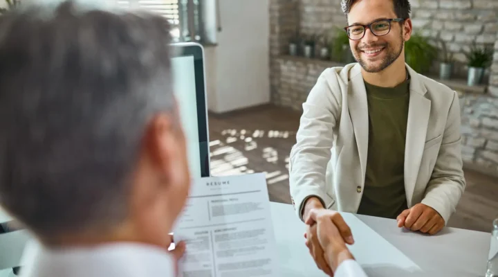male candidate greeting a member of human resource team on a job interview